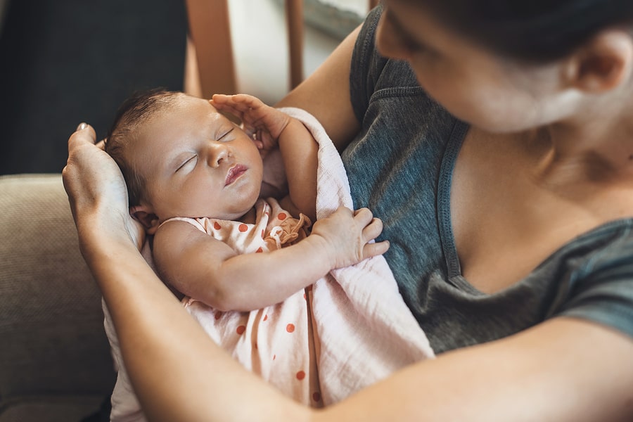 Moeder met pasgeboren baby in haar handen